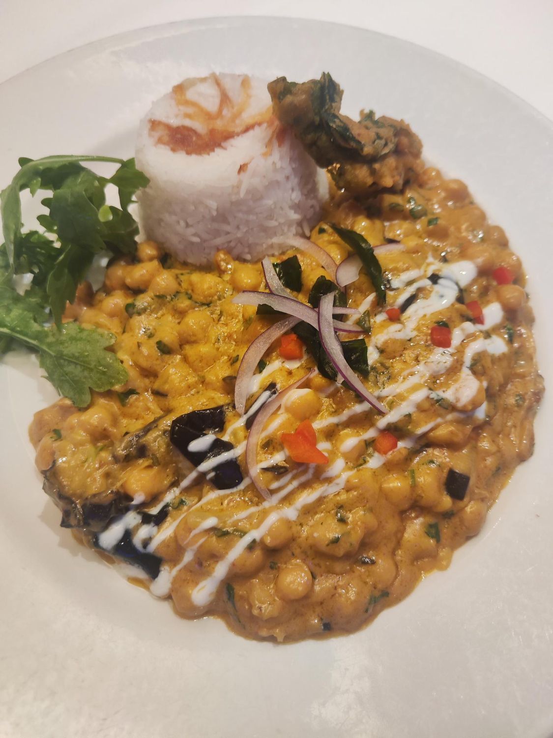 chickpea and baby aubergine curry singapore style. served with steamed rice.