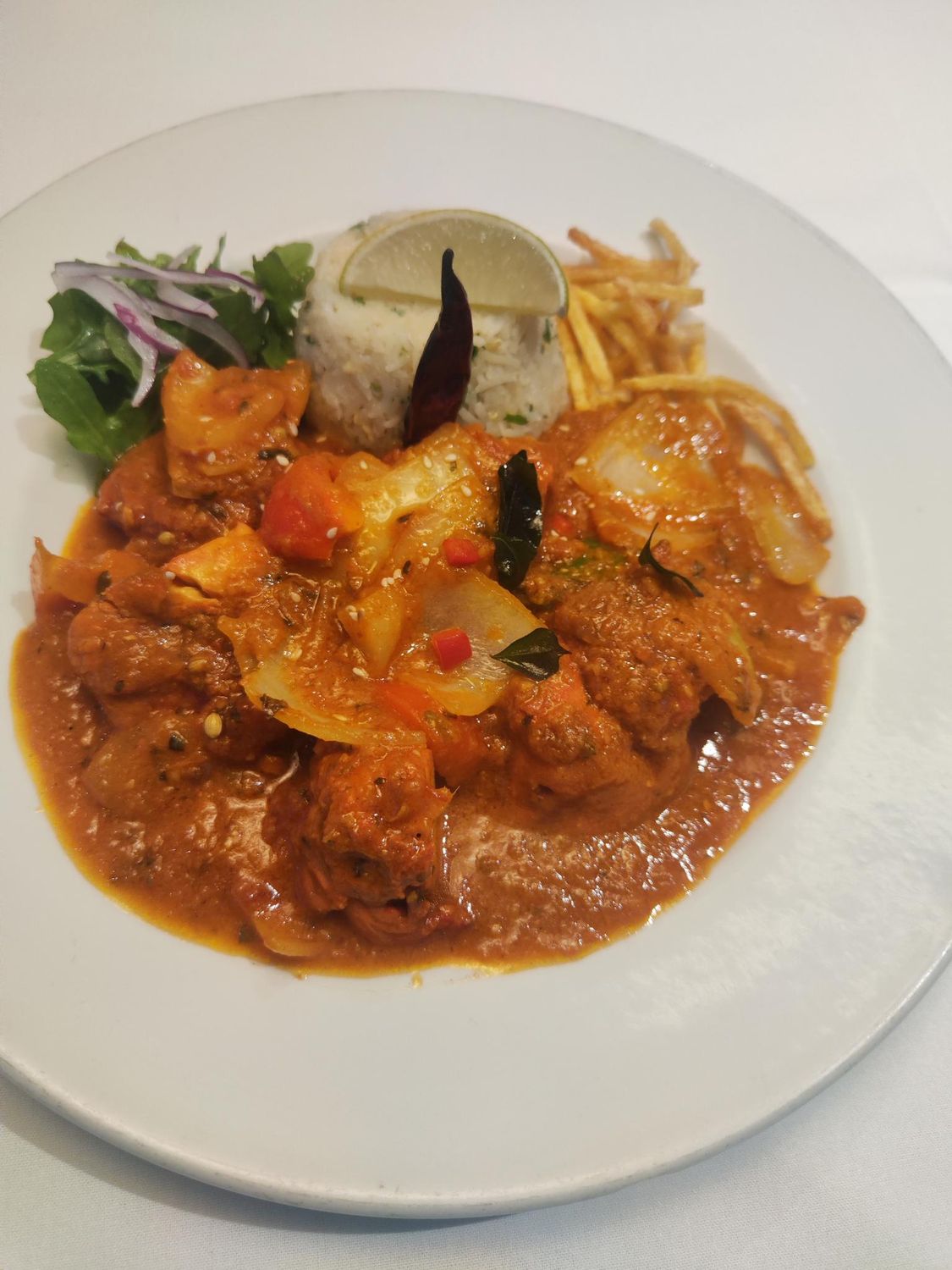 pakistani chicken korahi. served with egg rice.